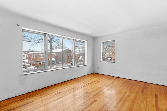 spare room featuring light wood-type flooring