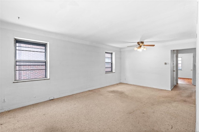 unfurnished room with ceiling fan and plenty of natural light