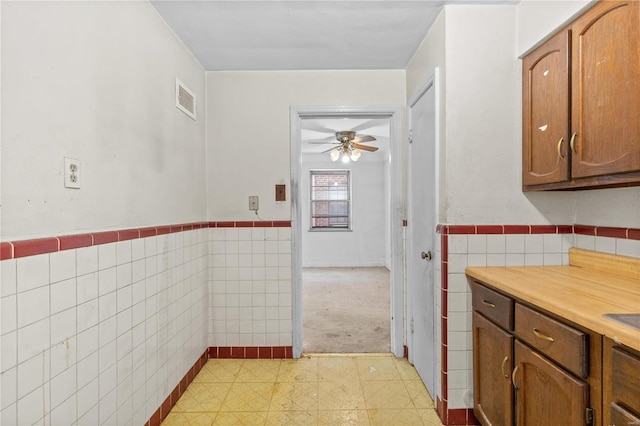 kitchen with tile walls and ceiling fan