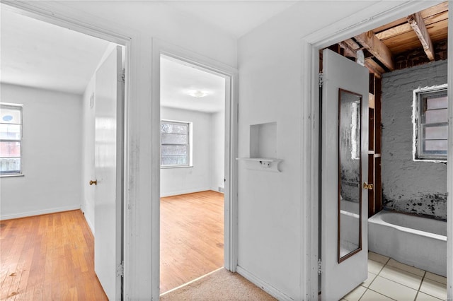 corridor with light tile patterned flooring