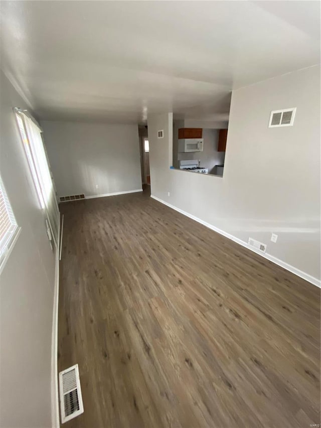 unfurnished living room featuring dark hardwood / wood-style flooring