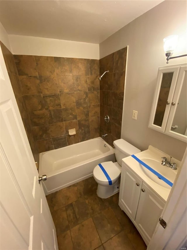 full bathroom featuring toilet, vanity, and tiled shower / bath