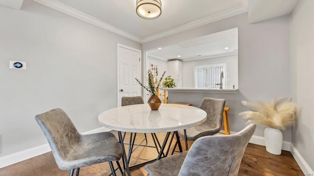 dining area with dark wood-type flooring and ornamental molding