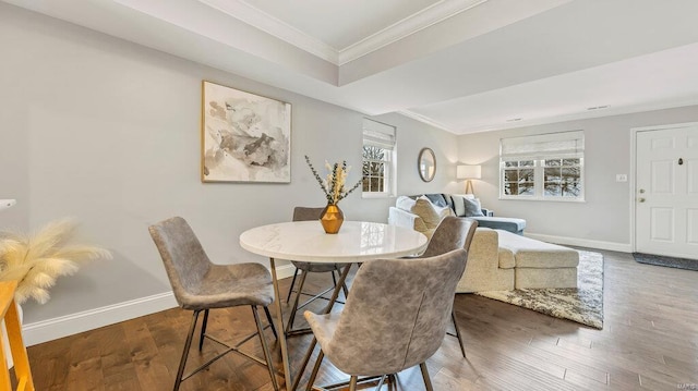 dining area featuring crown molding and dark wood-type flooring