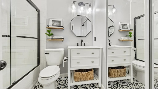 full bathroom featuring combined bath / shower with glass door, tile patterned floors, and toilet