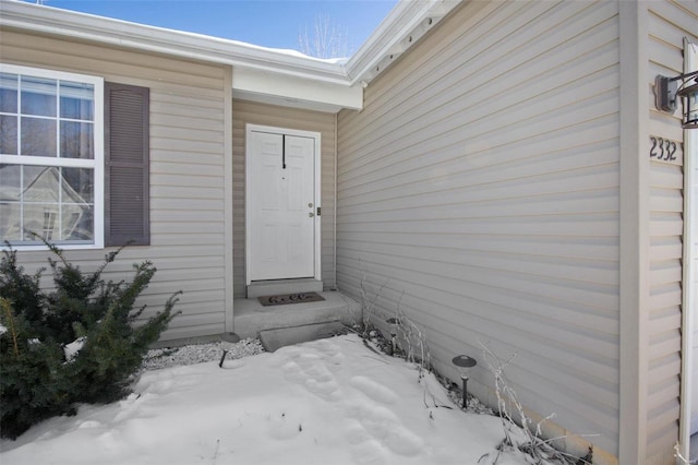 view of snow covered property entrance