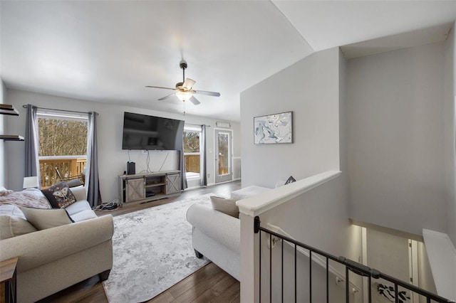 living room featuring a wealth of natural light, dark hardwood / wood-style flooring, lofted ceiling, and ceiling fan