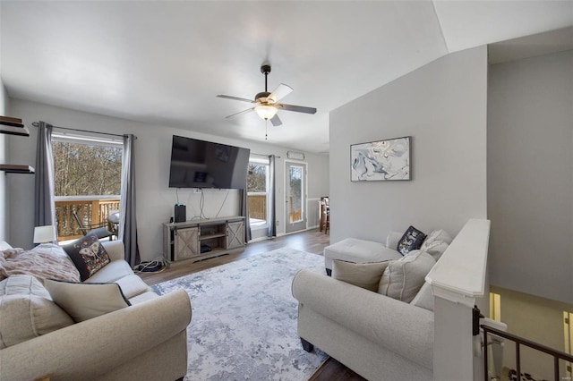 living room featuring lofted ceiling, ceiling fan, light hardwood / wood-style floors, and a healthy amount of sunlight