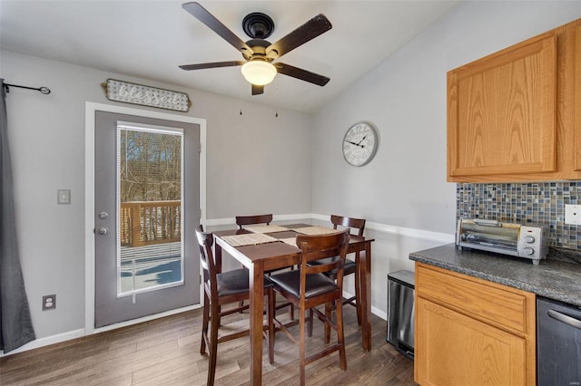 dining space with dark hardwood / wood-style flooring and ceiling fan