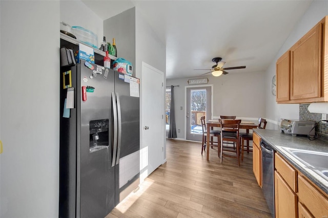 kitchen featuring stainless steel appliances, light hardwood / wood-style floors, backsplash, ceiling fan, and sink