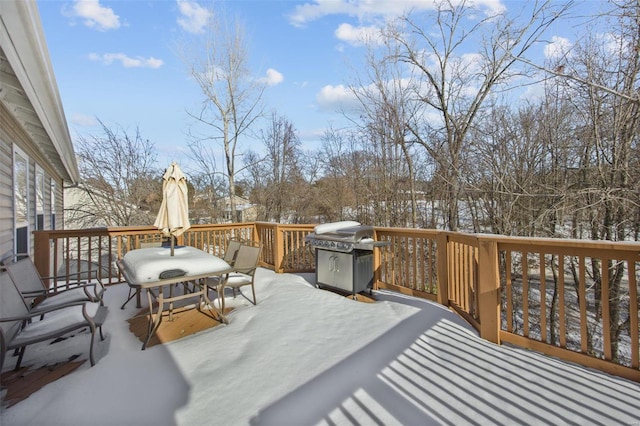 snow covered deck featuring grilling area