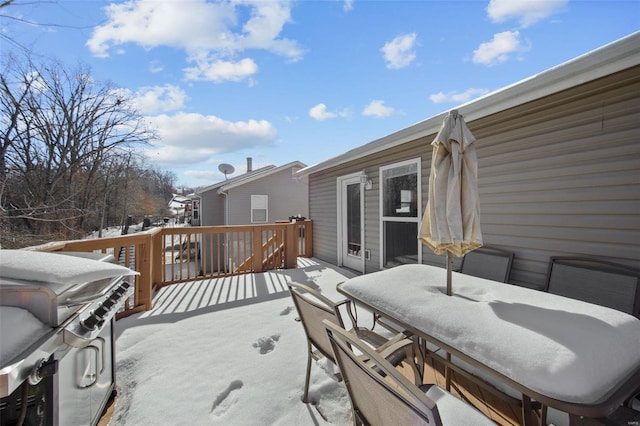 snow covered deck featuring a grill