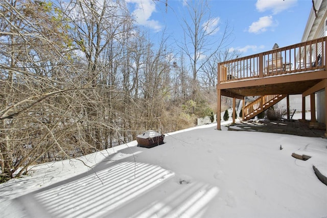 yard covered in snow featuring a deck