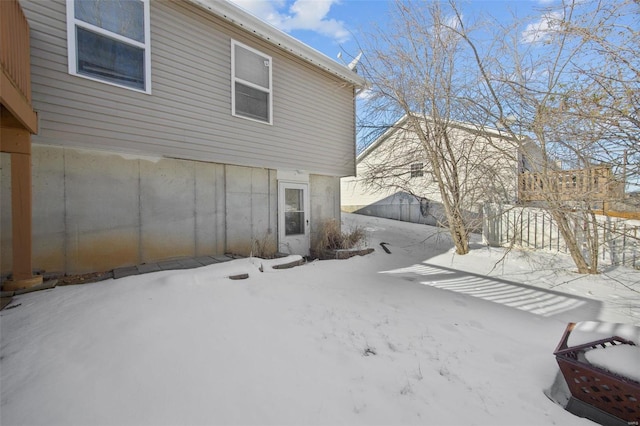 view of snow covered back of property