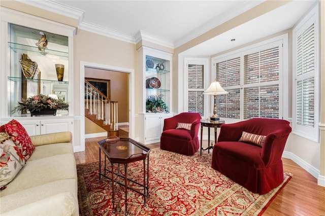 living room featuring ornamental molding and light hardwood / wood-style flooring