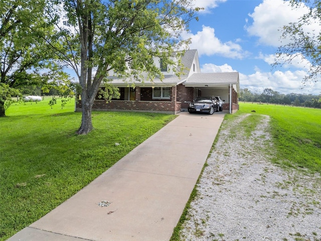 view of front of house with a front lawn and a carport