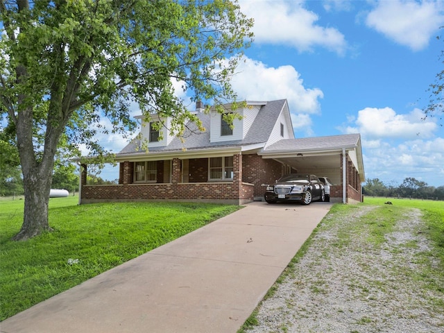 cape cod home featuring a front lawn and a carport