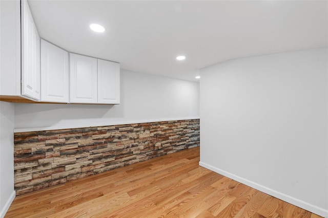 empty room with light hardwood / wood-style flooring