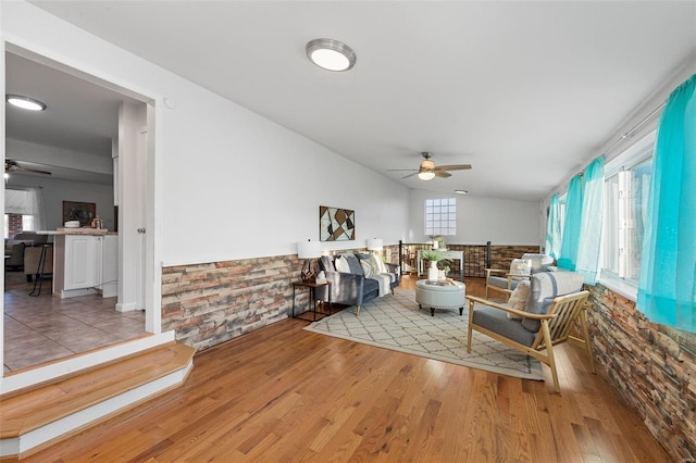 living room featuring wood-type flooring, plenty of natural light, ceiling fan, and lofted ceiling