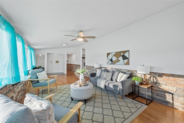 living room with wood-type flooring and ceiling fan