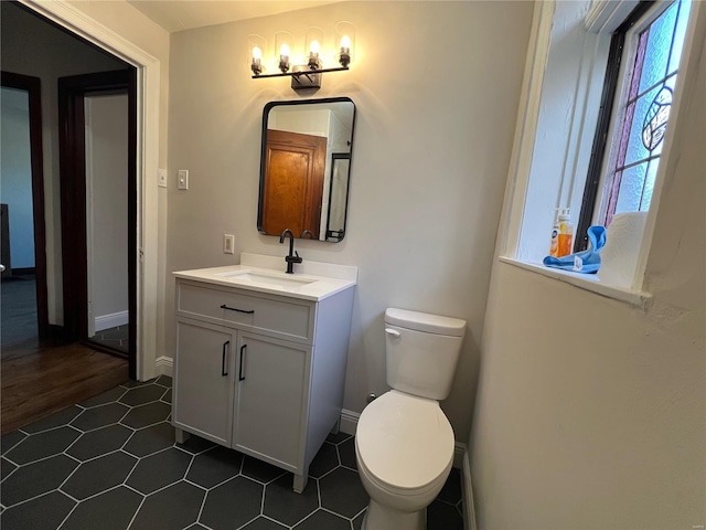 bathroom with tile patterned floors, vanity, and toilet