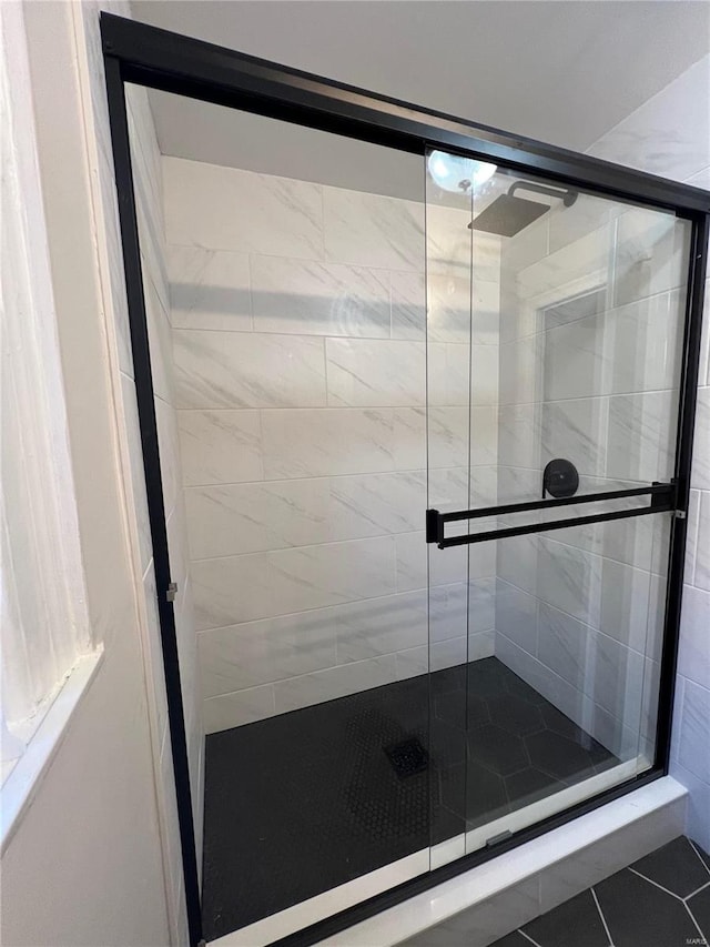 bathroom featuring tile patterned floors and an enclosed shower