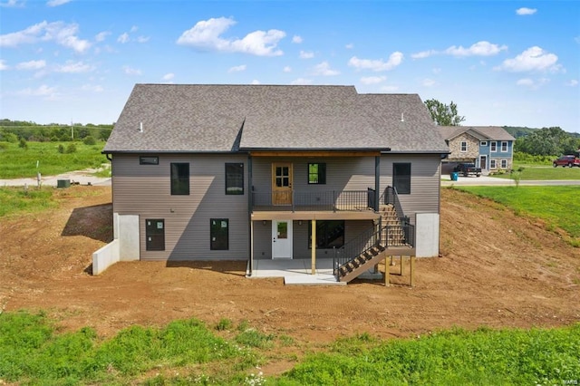 rear view of house featuring a patio and stairs