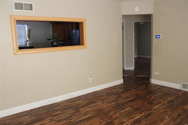 spare room with dark hardwood / wood-style flooring