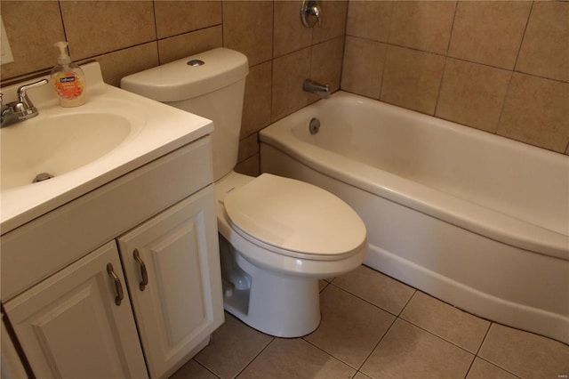 bathroom featuring tile patterned floors, tile walls, toilet, and vanity