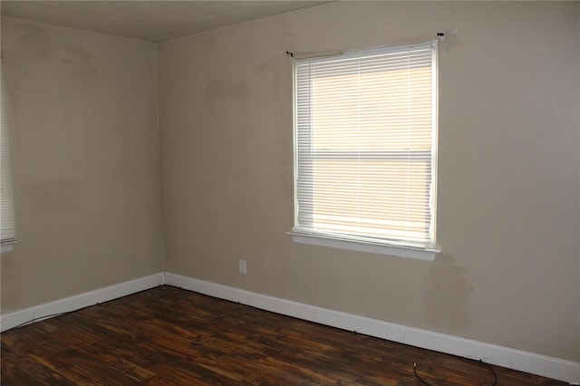 empty room with dark hardwood / wood-style flooring