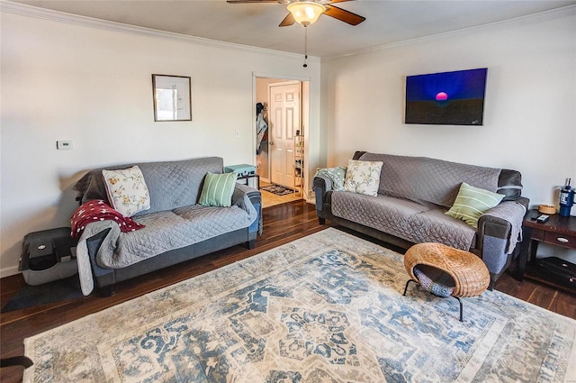 living room featuring dark wood-type flooring, ornamental molding, and ceiling fan