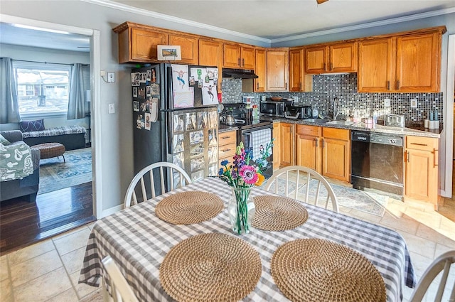 kitchen featuring ornamental molding, sink, tasteful backsplash, and black appliances