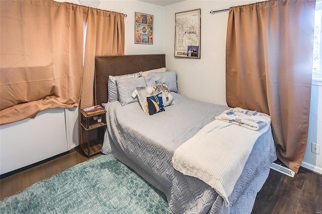 bedroom featuring dark hardwood / wood-style flooring