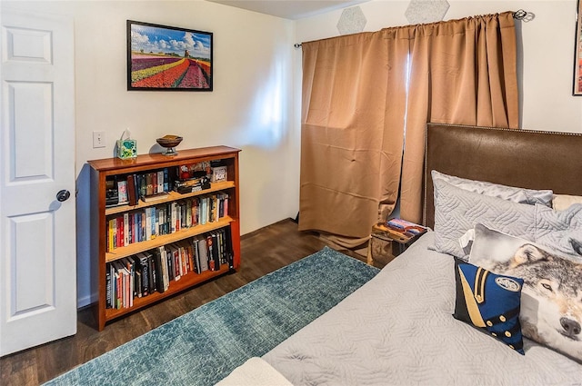 bedroom with dark wood-type flooring