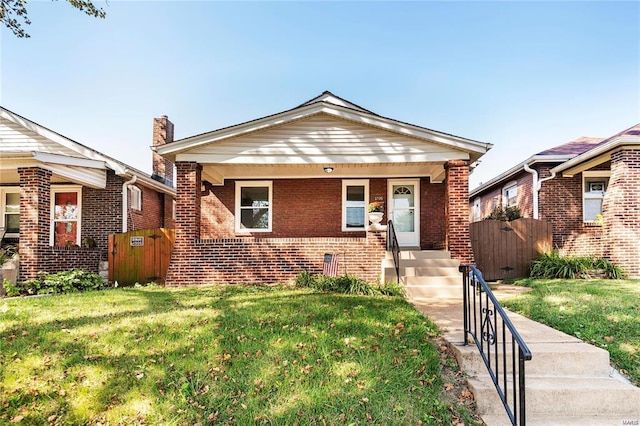 bungalow-style home with a front yard and a porch