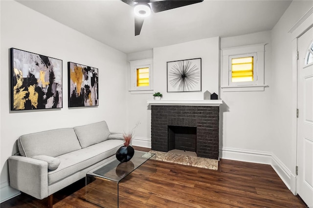 living room with ceiling fan, dark wood-type flooring, and a fireplace