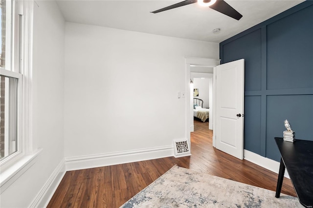 bedroom with ceiling fan and dark wood-type flooring