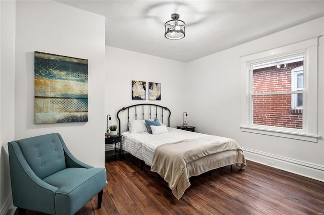 bedroom with dark wood-type flooring