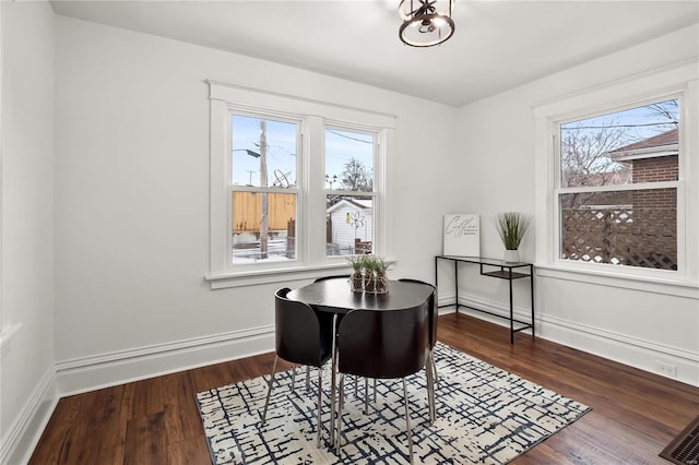 office space with a wealth of natural light and dark hardwood / wood-style floors