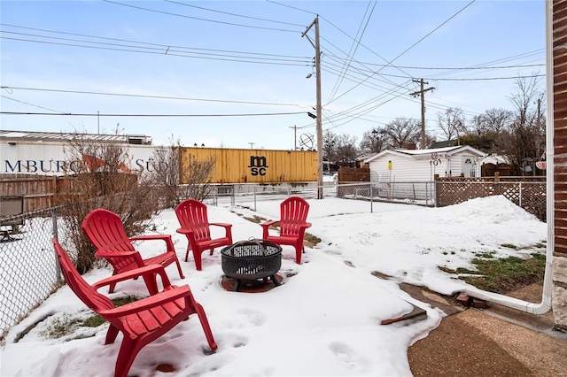 yard covered in snow featuring a fire pit