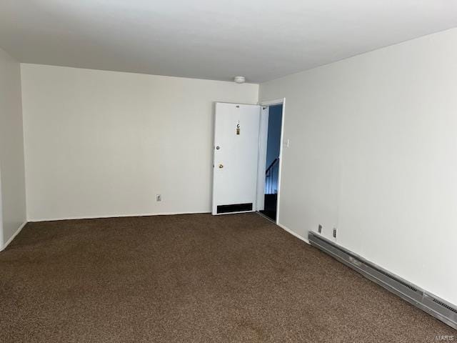 unfurnished room featuring a baseboard radiator and dark carpet