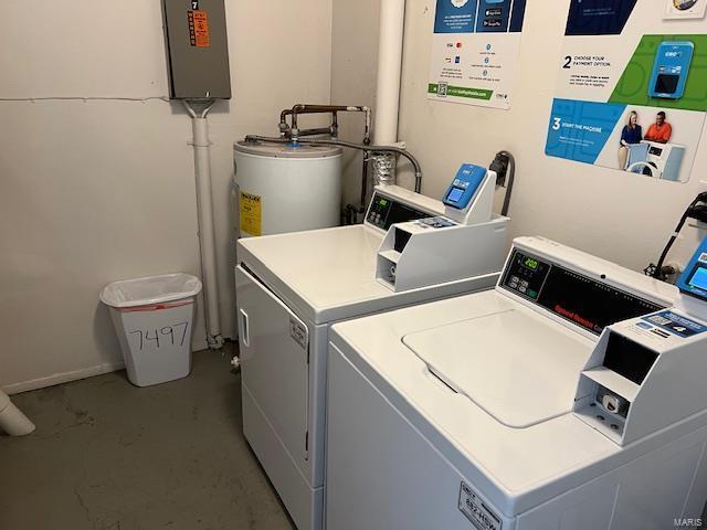 washroom with water heater and washing machine and clothes dryer