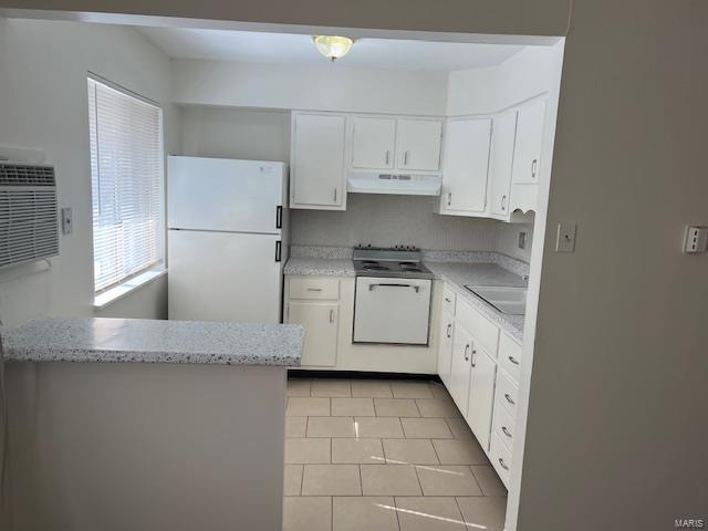 kitchen with sink, white cabinetry, white appliances, light tile patterned floors, and light stone countertops