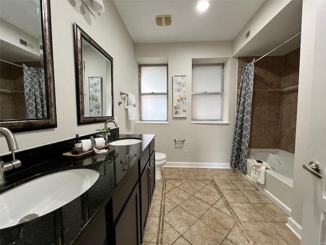 full bathroom featuring tile patterned flooring, shower / bath combination with curtain, vanity, and toilet