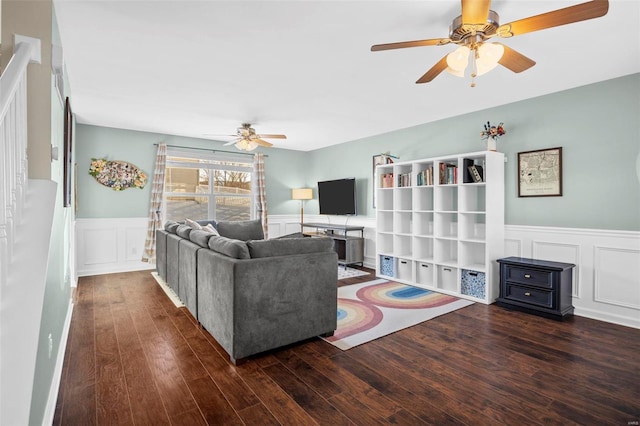 living room with ceiling fan and dark hardwood / wood-style flooring