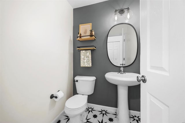 bathroom featuring sink, tile patterned flooring, and toilet