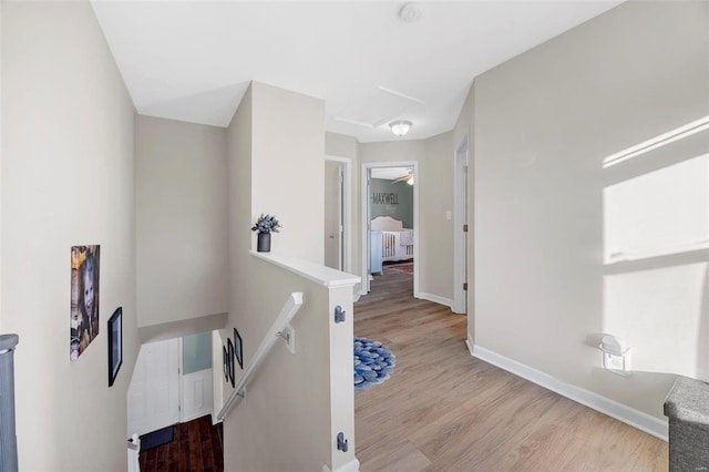 corridor with light hardwood / wood-style flooring