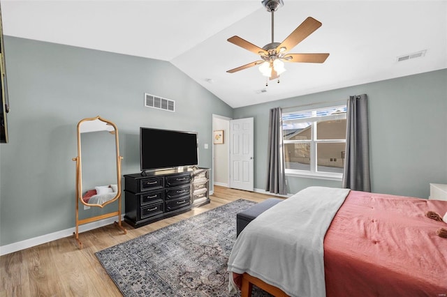 bedroom with ceiling fan, light hardwood / wood-style flooring, and lofted ceiling