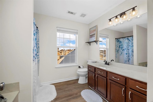 bathroom featuring toilet, hardwood / wood-style flooring, curtained shower, and vanity