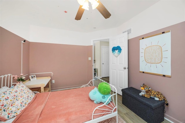 bedroom with hardwood / wood-style floors and ceiling fan